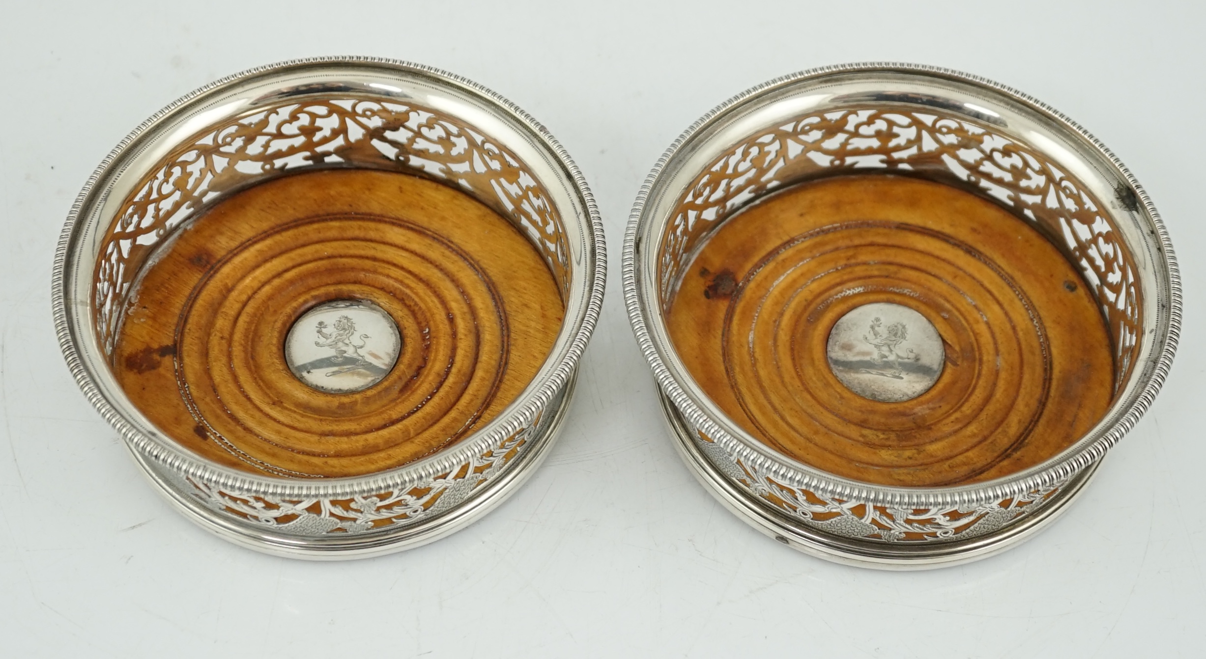 A pair of George III pierced silver mounted wine coasters, William Allen III